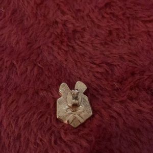 A present shaped pin or brooch